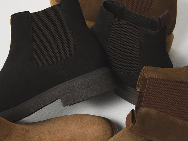 Cluster of black and brown suede boots.